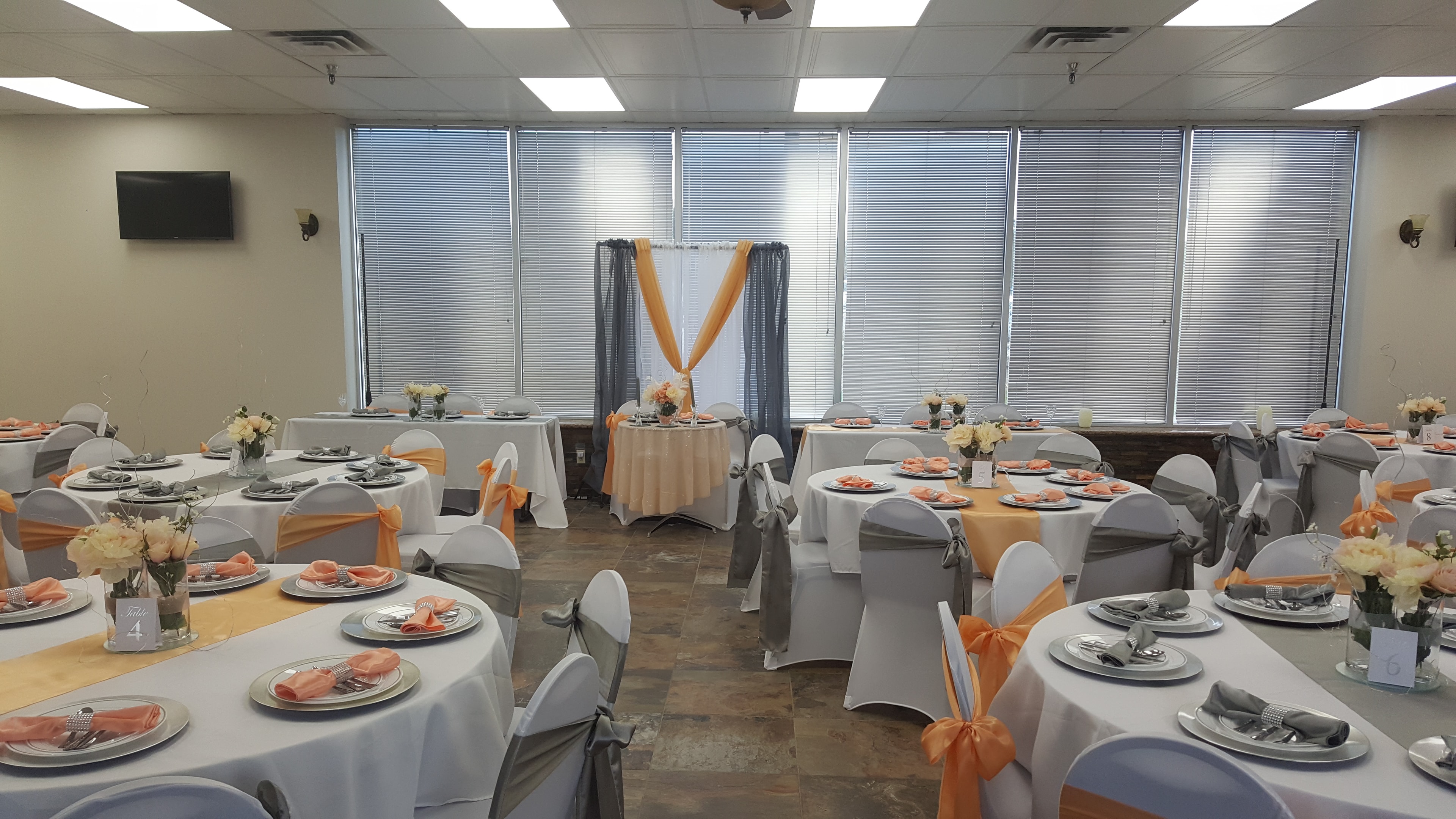 Deja Vu Event Space banquet room with peach and gray reception decor