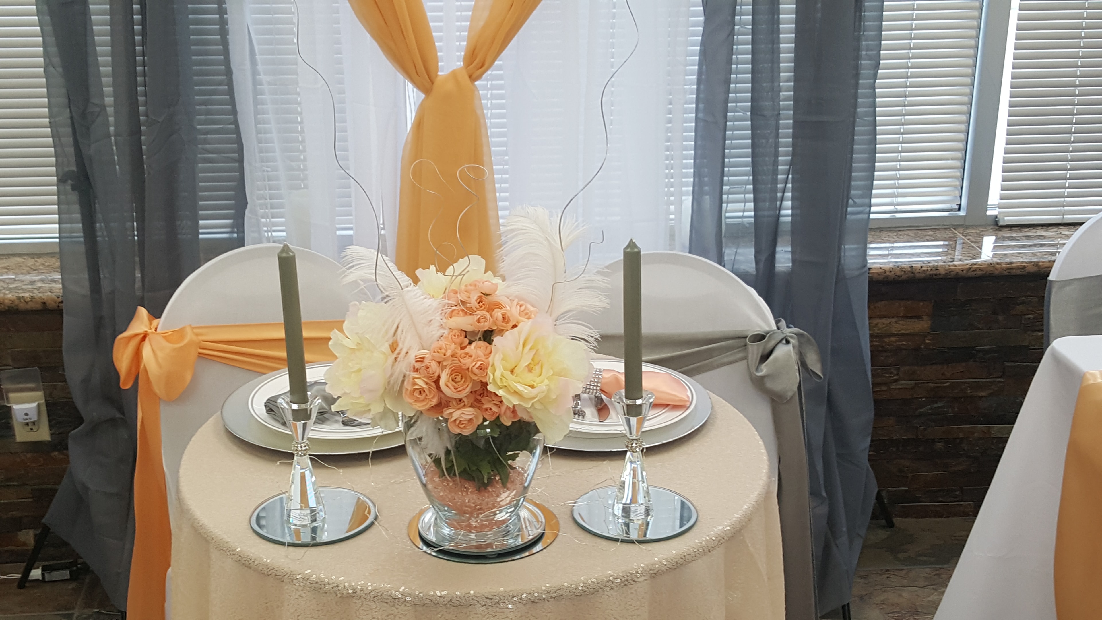 Peach and gray head table with floral centerpiece at Deja Vu Event Space
