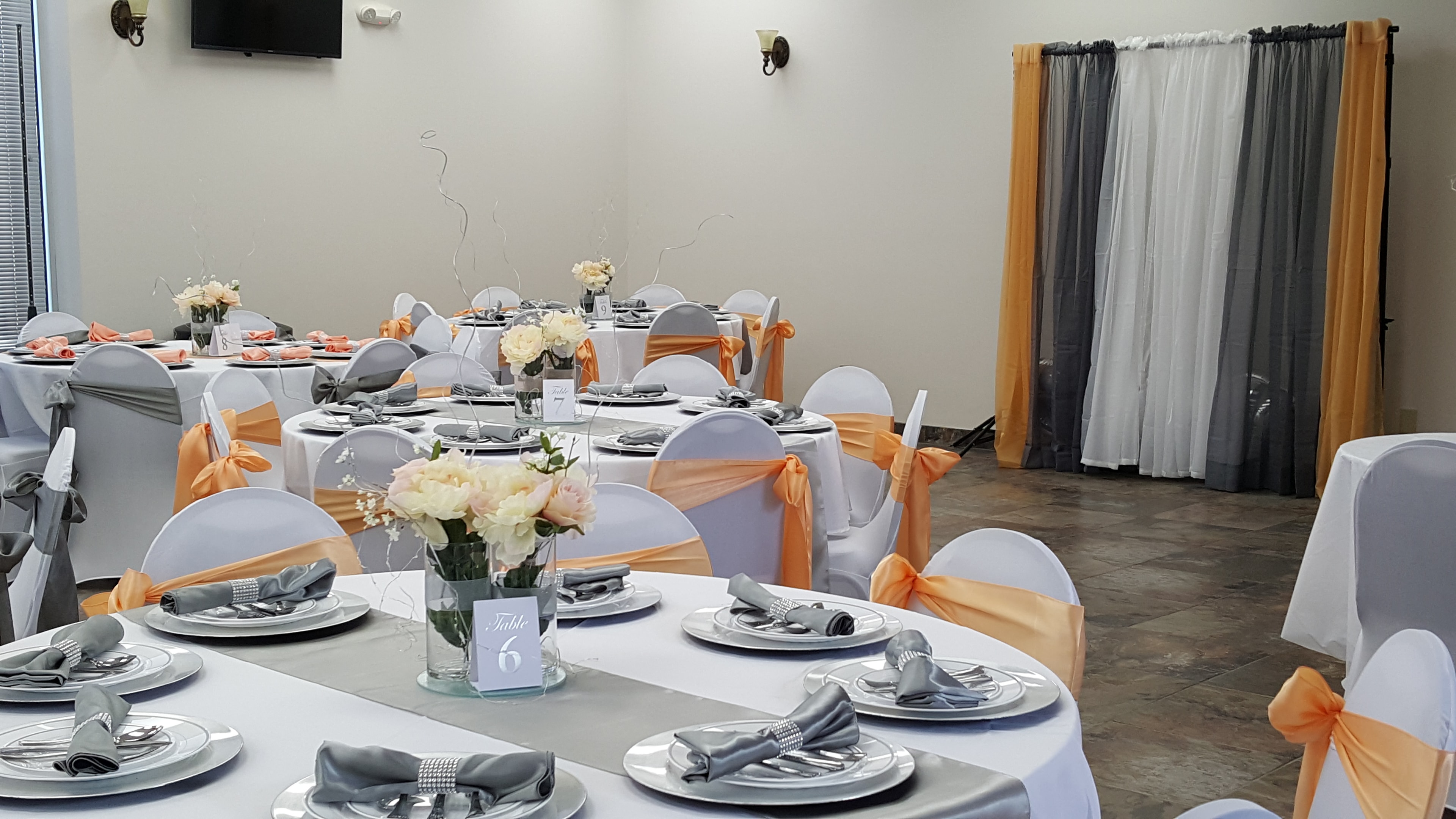Reception room with peach and gray chair accents at Deja Vu Event Space