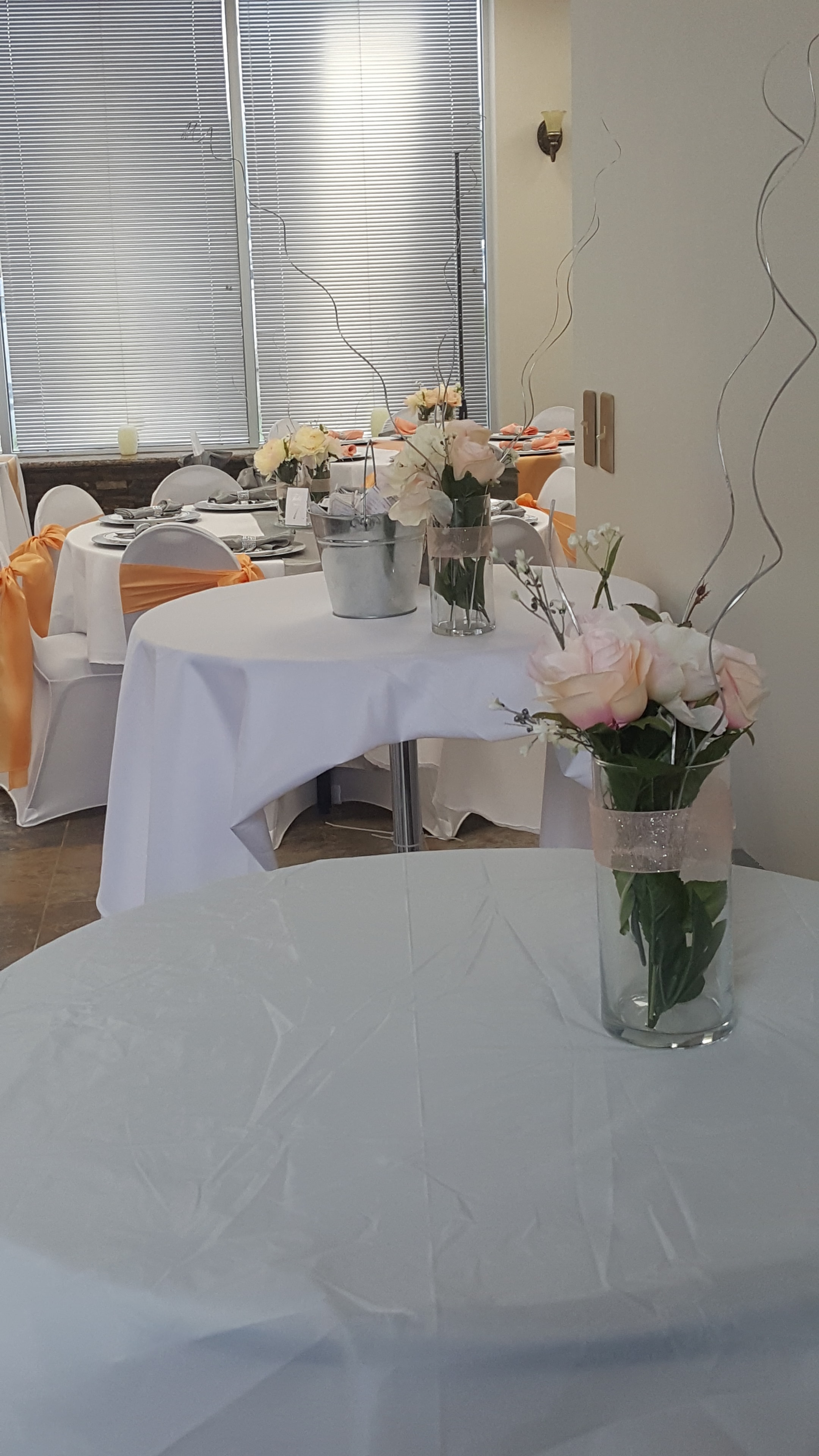 Elegant peach and gray floral table setting at Deja Vu Event Space